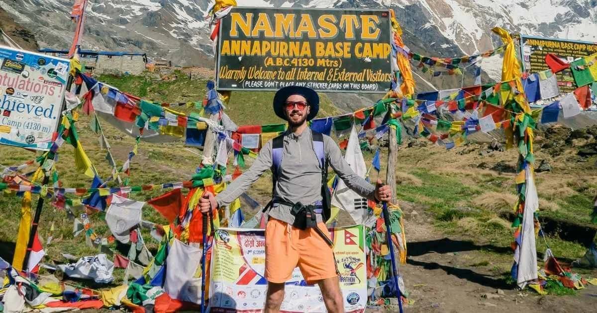 Trekker posing himself infront of ABC Signboard