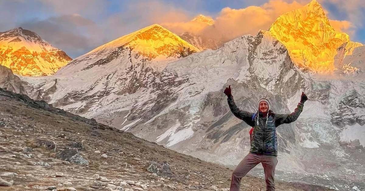 Trekker posing himself infront of Mt Everest at Everest Base Camp